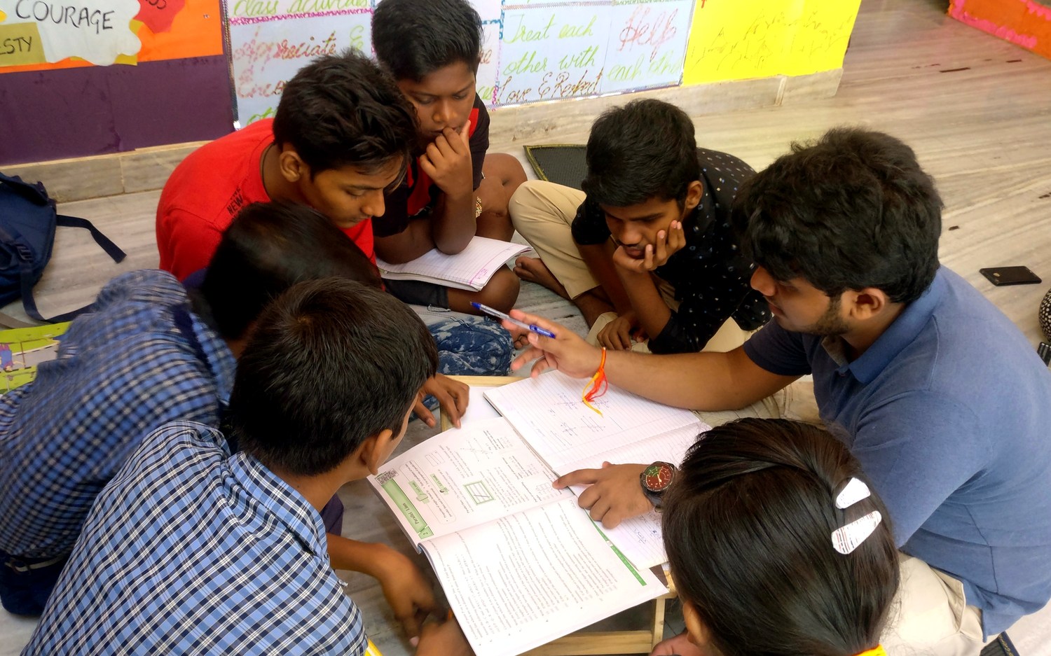 A mentor guiding students through their studies at Touching Lives